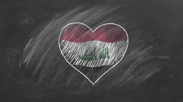 National flag of Iraq in heart shape  drawn with colored chalk on a school blackboard.