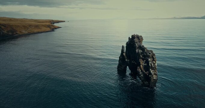 Rugged sea stack rising from the ocean off Iceland