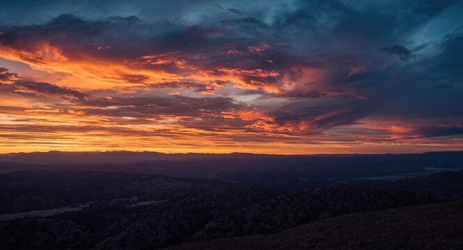 Vast scenic panorama featuring a glowing sky and dramatic sunset colors
