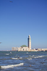 Hassan II Mosque in Casablanca with seabirds over Atlantic Ocean