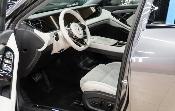 Voyah Free elegant E-SUV white interior, steering wheel, dashboard, setting buttons. Voyah is EV brand of Chinese State-owned automaker Dongfeng Motor Corporation.