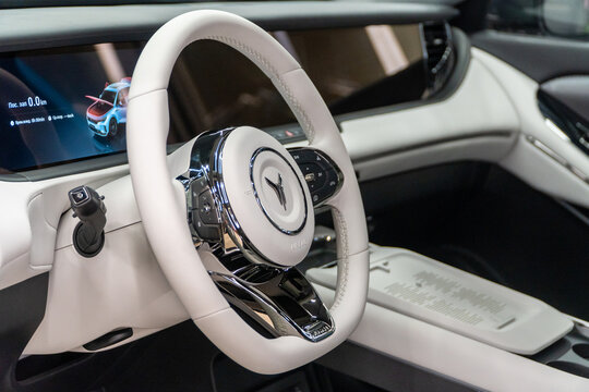 Voyah Free elegant E-SUV white interior, steering wheel, dashboard, setting buttons. Voyah is EV brand of Chinese State-owned automaker Dongfeng Motor Corporation.