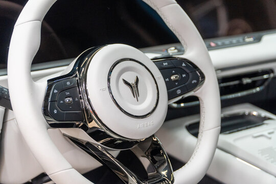 Voyah Free elegant E-SUV white interior, steering wheel, dashboard, setting buttons. Voyah is EV brand of Chinese State-owned automaker Dongfeng Motor Corporation.