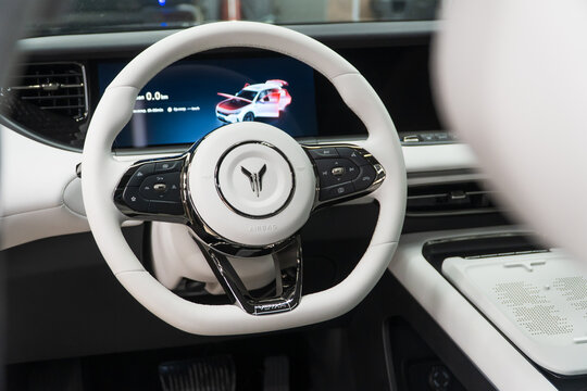 Voyah Free elegant E-SUV white interior, steering wheel, dashboard, setting buttons. Voyah is EV brand of Chinese State-owned automaker Dongfeng Motor Corporation.