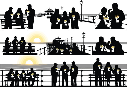 Diverse groups of people enjoying fish and chips by the sea on a pier, silhouetted against the sunset, conveying leisure and casual dining.
