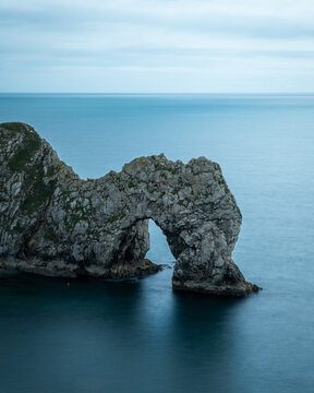 View of the majestic Durdle Door, a natural limestone arch standing defiant against the relentless caress of the turquoise sea, Wareham, United Kingdom.