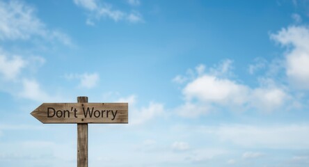 Dont Worry signpost framed by an expansive sky and drifting clouds