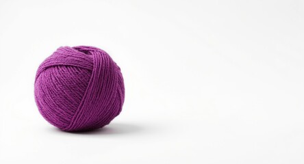 Purple textile yarn ball featured on an immaculate white backdrop for crafting themes