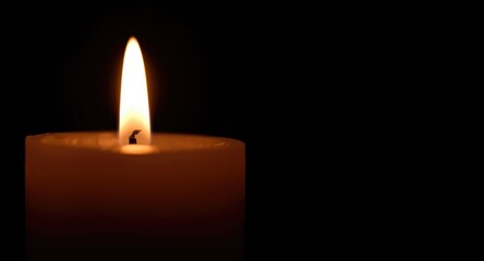 Close detailed capture of candlelight on solid black background
