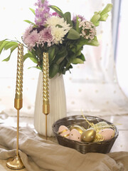 Spring tabletop scene with flowers and candles