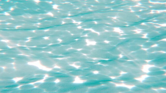 Realistic Simply underwater sunlight caustics with some GodRays on fine sandy ocean floor with two caustics effect rocks - Crystal clear blue sea 3D render seamless loop animation.