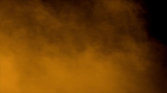 Realistic orange smoke or fog rolling across the screen from the bottom left. Isolated on black for compositing as a warm ground fog, fire aftermath, or moody transition
