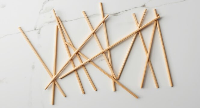 Mikado sticks laid flat in random order on a white tabletop