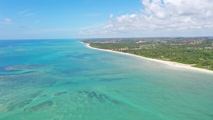 Wonderful view of white sand beach with turquoise waters and coral reefs in Milagres route near Maceio city, Alagoas State, Brazil 