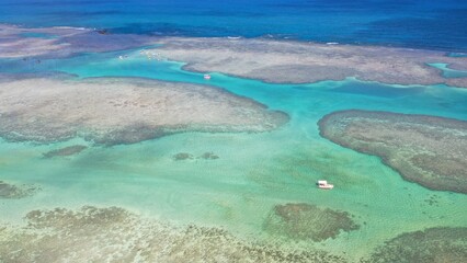 Obraz premium Wonderful view of white sand beach with turquoise waters and coral reefs in Milagres route near Maceio city, Alagoas State, Brazil 