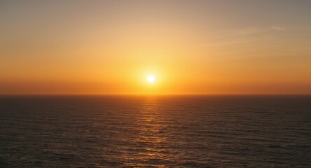 Fototapeta premium Golden sunrise spreading light over peaceful sea expanse