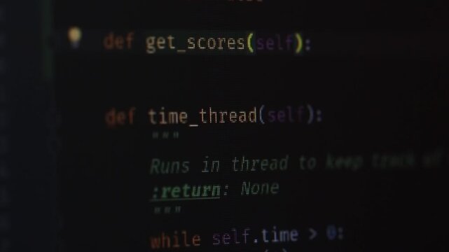 The program code on the monitor screen is close