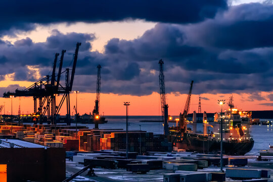 Dramatic sky over cargo containers and container ships in the port of Klaipeda at dusk, Lithuania