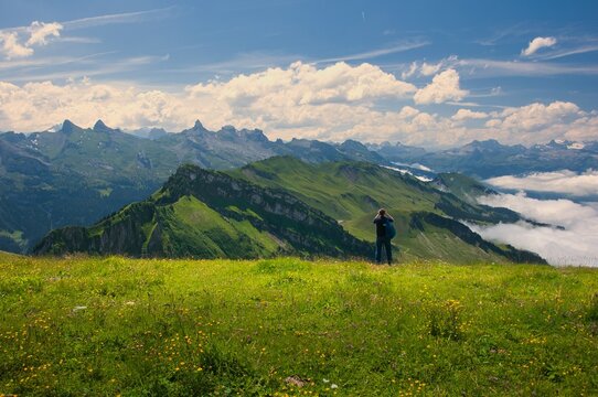 Rear view of a man standing in the mountains looking at the view, Hasli, Bernese Oberland, Bern, Switzerland