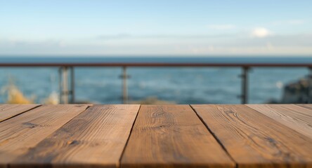 Fototapeta premium wooden table on deck with blurred ocean background for website mockup
