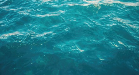 Vibrant aqua sea water surface rough texture background with diffused daylight and copy space