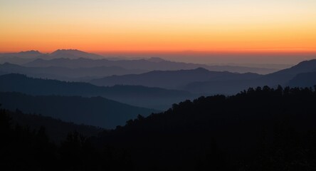 Tranquil sunrise scene with layered mountain peaks and serene atmosphere