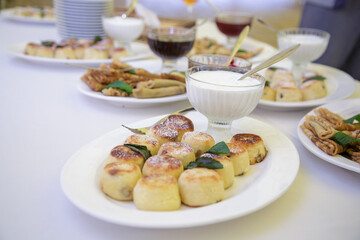 Assorted sweet pastries and desserts arranged on festive banquet table during corporate celebration event.