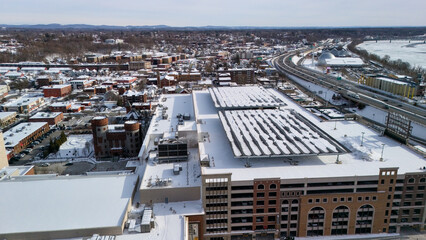 Fototapeta premium Aerial view of Springfield Massachusetts highway and rooftops in winter snow