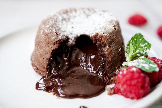 Homemade Chocolate molten lava cake served with raspberries and powdered sugar