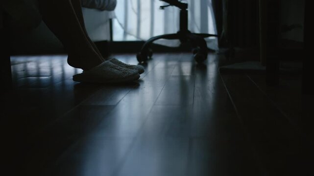 Close Up of Plus Size Woman Putting On Slippers and Stepping Out of Bedroom Into Windy Evening Weather
