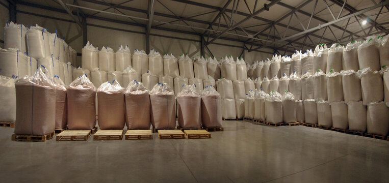 big-bags with grain or fertilizers on wooden pallets in a agriculture warehouse