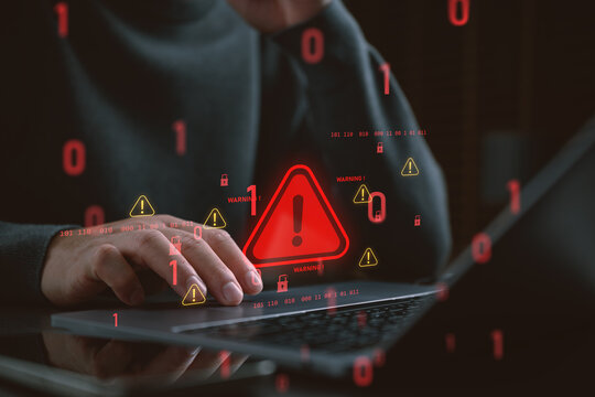 Cyber security breach and hacking concept with hand on laptop and red warning alert icons. Digital system vulnerability, data privacy risk, internet fraud and unauthorized computer access.