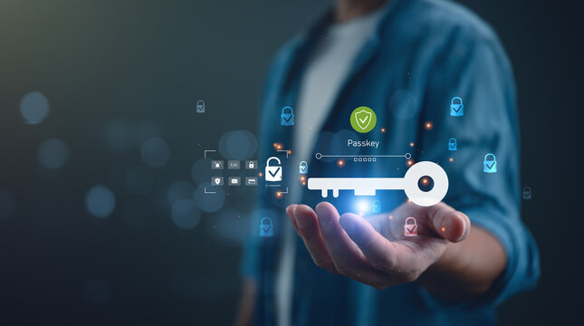 Close up of hand holding virtual passkey icon with shield for secure login. Concept of passwordless authentication, cyber security, digital identity protection, and future technology.