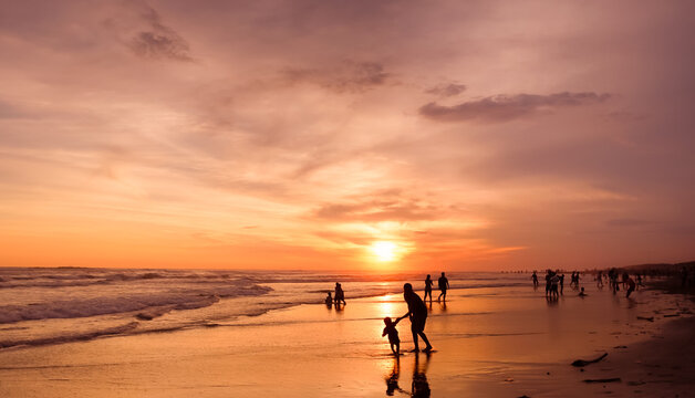 Dramatic colorful sunset seascape at Parangtritis Beach, Yogyakarta with ocean waves and silhouettes