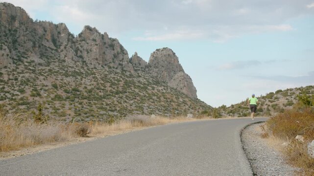 Adult Woman with Overweight Jogging in Countryside Mountain Area in Evening for Fitness Improvement
