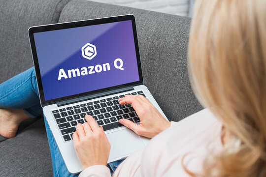 Woman using laptop with amazon q logo