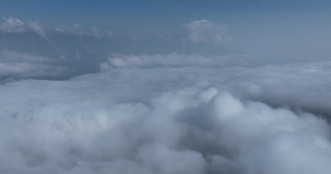 Aerial footage landscape of couds and snow capped mountains in sichuan, China