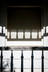 Worn veranda balustrade and shadows on a white house, Hobart, Tasmania, Australia