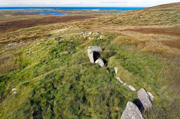 South Clettraval Chambered Cairn prehistoric tomb in foreground on S slope of South Clettraval, North Uist. View to W over adjacent wheelhouse behind © David Matthew Lyons