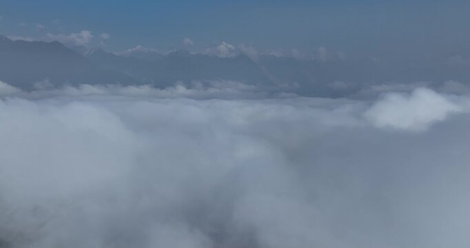 Aerial footage landscape of couds and snow capped mountains in sichuan, China