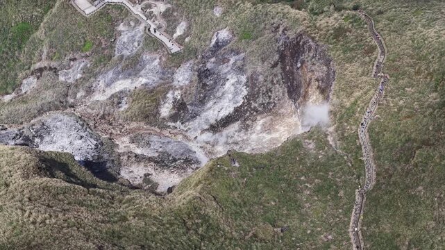Aerial view of steaming volcanic fumarole with hiking trails