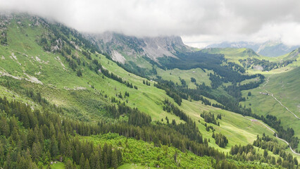 Obraz premium Hiking trail round the Gastlosen mountain in the Swiss Alps. outdoor adventure, hiking destination in in Switzerland, alpine trees and mountains in background. Outdoor travel destination. Beautiful na
