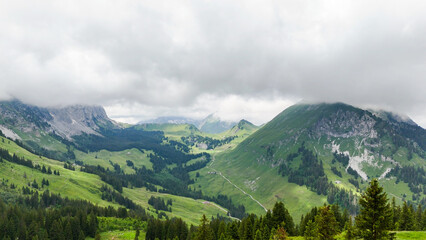 Obraz premium Hiking trail round the Gastlosen mountain in the Swiss Alps. outdoor adventure, hiking destination in in Switzerland, alpine trees and mountains in background. Outdoor travel destination. Beautiful na