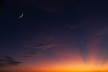 Night Ramadan Sky Background with Islamic Crescent Moon for Eid Mubarak,Summer sunset Blue,Purple,Orange Dusk sky.Horizon scenic sunset.Nature landscape Background for month of Muslim,Islam religion © Anchalee
