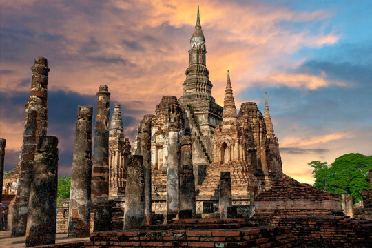 Sukothai pagoda with stone Buddha in historical park in mid northern Thailand