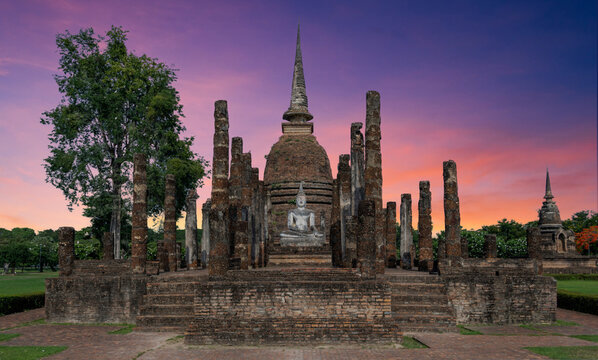 Sukothai pagoda with stone Buddha in historical park in mid northern Thailand