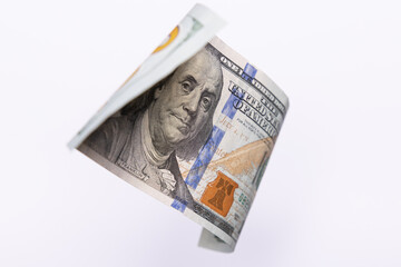 Single 100 US Dollar Bill Flying over Light Background