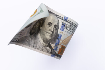 Single 100 US Dollar Bill Flying over Light Background