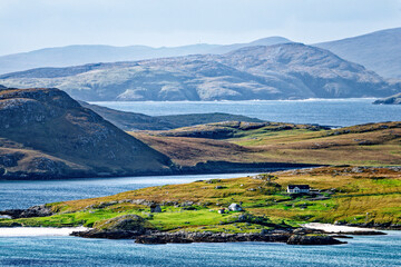 South from the slopes of Heaval on Barra across Castle Bay to crofts on east coast of Vatersay with the islands of Sandray, Pabbay and Mingulay behind © David Matthew Lyons