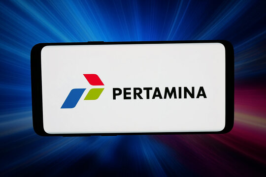 Stuttgart, Germany - 02-23-2026: In this photo illustration, the logo of Indonesian company PT Pertamina (Persero) is displayed on a smartphone in front of abstract background on computer screen.